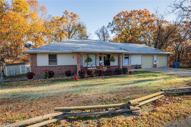 single story home with a front yard, a garage, and covered porch