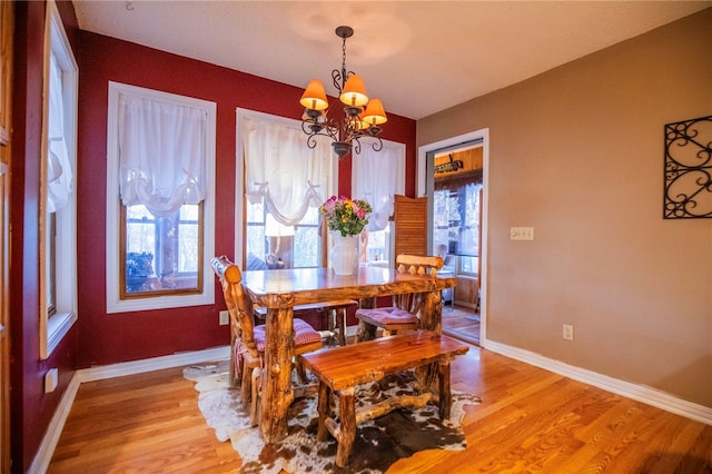 dining area with a chandelier, a healthy amount of sunlight, and light hardwood / wood-style floors