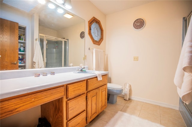 bathroom featuring tile patterned floors, vanity, toilet, and walk in shower