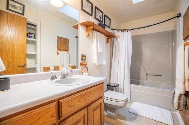 full bathroom featuring vanity, a skylight, tile patterned flooring, a textured ceiling, and shower / tub combo with curtain