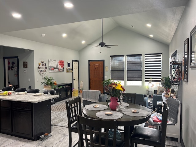 dining space featuring ceiling fan and high vaulted ceiling