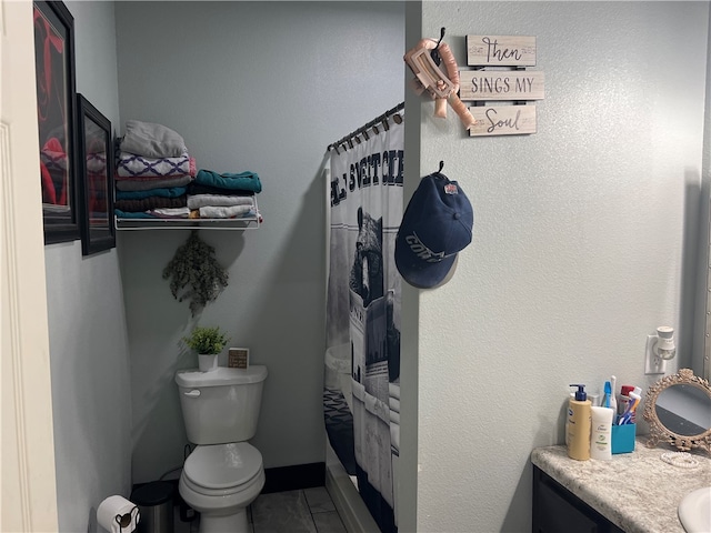 bathroom with a shower with shower curtain, tile patterned floors, vanity, and toilet