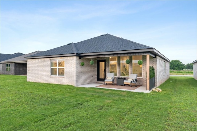 6309 NW Harley St, Bentonville, AR 72713 - rear view of house with brick siding, a patio, a lawn, and a shingled roof