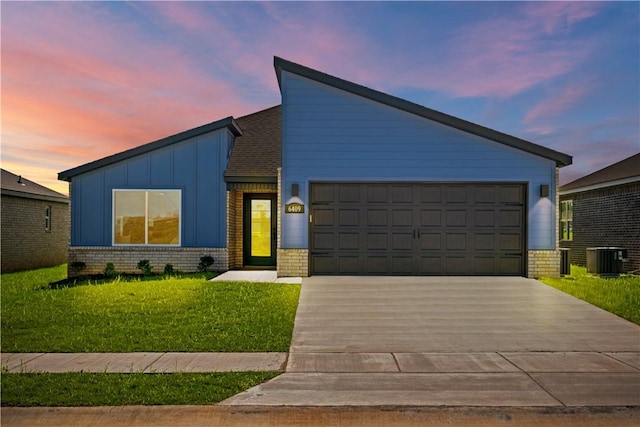 6309 NW Harley St, Bentonville, AR 72713 - mid-century inspired home featuring driveway, brick siding, a lawn, and a garage