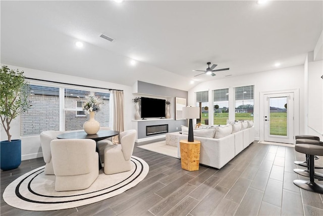 6309 NW Harley St, Bentonville, AR 72713 - living room featuring ceiling fan, vaulted ceiling, wood finished floors, a glass covered fireplace, and recessed lighting