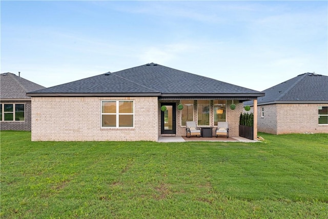 6309 NW Harley St, Bentonville, AR 72713 - back of property with a patio, a shingled roof, a yard, and brick siding