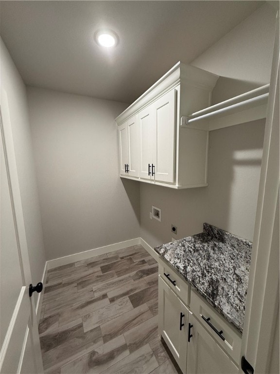 laundry room featuring cabinets, hookup for a washing machine, light wood-type flooring, and hookup for an electric dryer