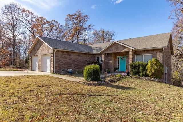 ranch-style home with a garage and a front lawn