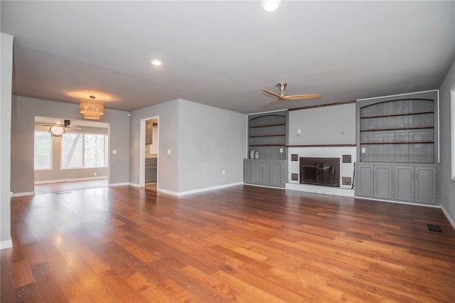 unfurnished living room with hardwood / wood-style flooring, a fireplace, and ceiling fan