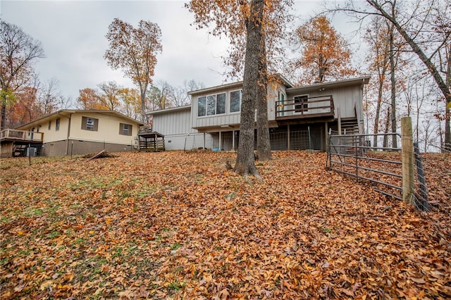 rear view of house featuring a wooden deck