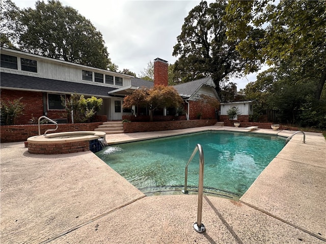 view of pool featuring an in ground hot tub, a patio, and a diving board