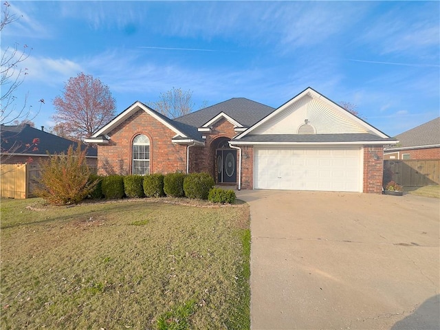 single story home featuring a garage and a front yard