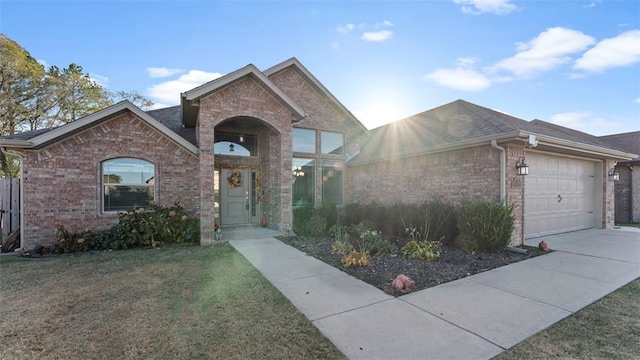 view of front of property with a front yard and a garage