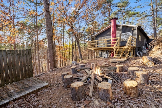 10305 Jims Trl, Rogers, AR 72756 - view of yard featuring a wooden deck, an outdoor fire pit, and stairway