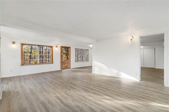10305 Jims Trl, Rogers, AR 72756 - unfurnished living room with wood finished floors and baseboards