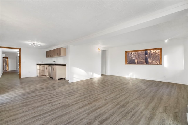 10305 Jims Trl, Rogers, AR 72756 - unfurnished living room featuring wood finished floors and baseboards