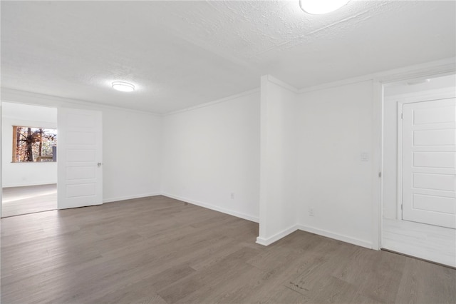 10305 Jims Trl, Rogers, AR 72756 - empty room featuring wood finished floors, a textured ceiling, and baseboards