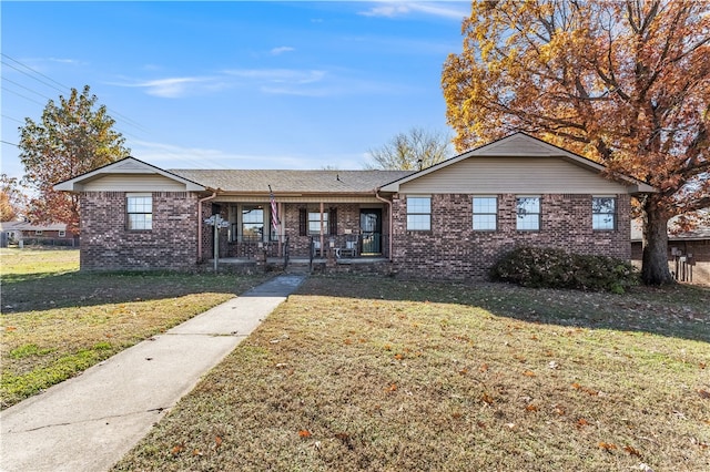 ranch-style house with a porch and a front yard