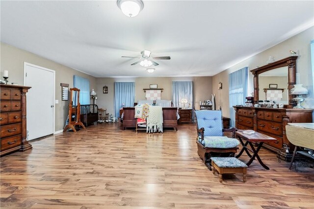 sitting room featuring ceiling fan and light hardwood / wood-style flooring