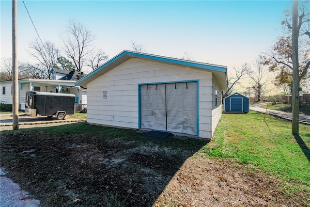 garage featuring a lawn