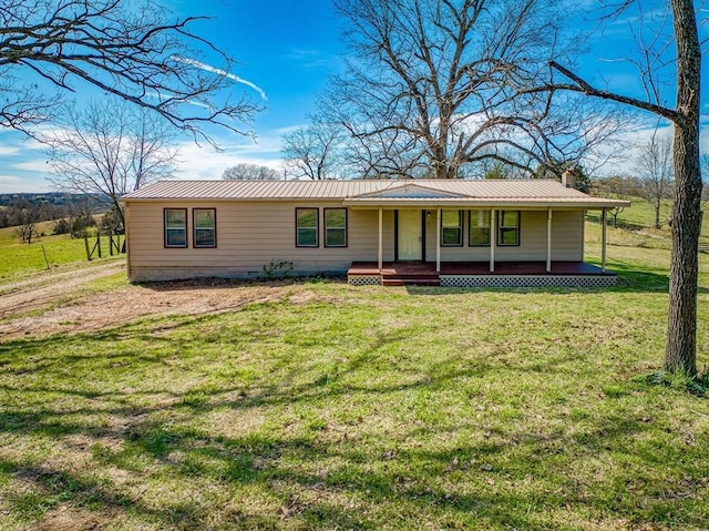 ranch-style home with a front lawn and covered porch