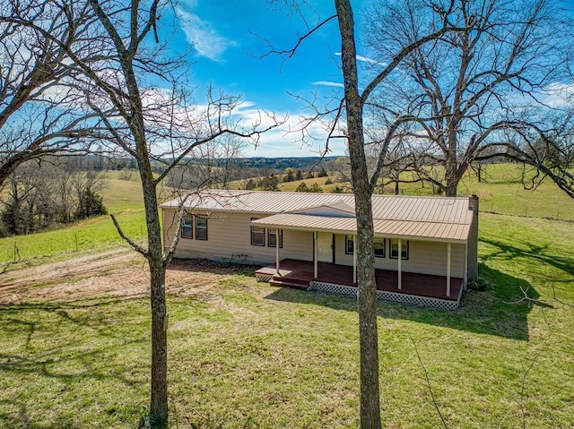 back of property featuring a yard