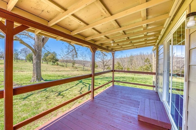 wooden terrace featuring a lawn