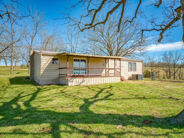 view of front of house featuring central AC unit and a front lawn