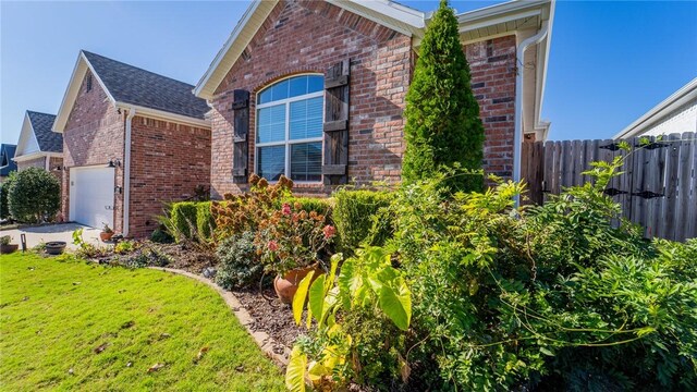 view of property exterior featuring a yard and a garage