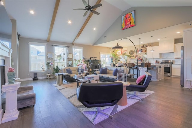 living area with dark wood finished floors, high vaulted ceiling, a wealth of natural light, and a ceiling fan