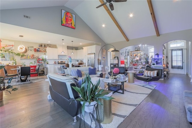 living area featuring visible vents, high vaulted ceiling, a ceiling fan, wood finished floors, and arched walkways