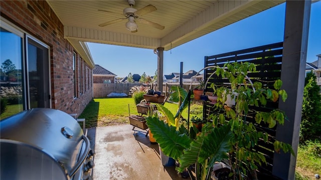 view of patio / terrace featuring area for grilling, a fenced backyard, and a ceiling fan