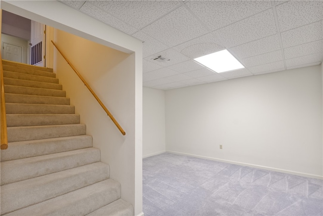 basement with a drop ceiling and carpet floors