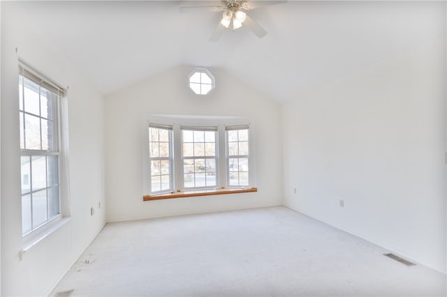 spare room featuring a wealth of natural light, lofted ceiling, and ceiling fan