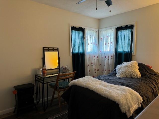 bedroom featuring dark hardwood / wood-style flooring and ceiling fan