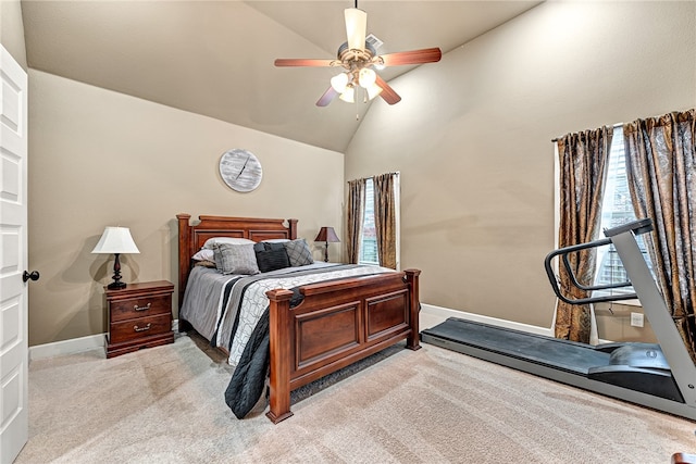 carpeted bedroom with ceiling fan and high vaulted ceiling