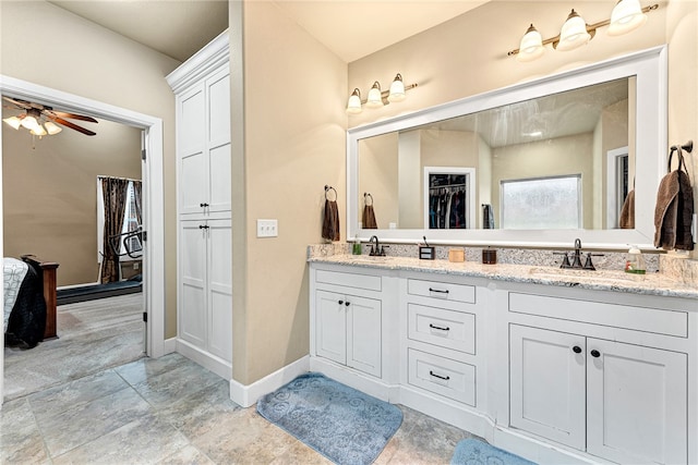 bathroom featuring ceiling fan and vanity