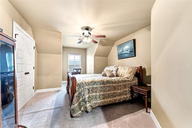 bedroom with carpet flooring, vaulted ceiling, and ceiling fan