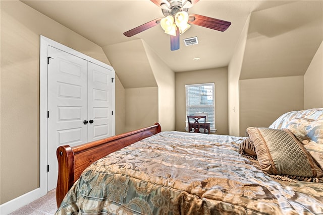 carpeted bedroom featuring a closet, ceiling fan, and lofted ceiling