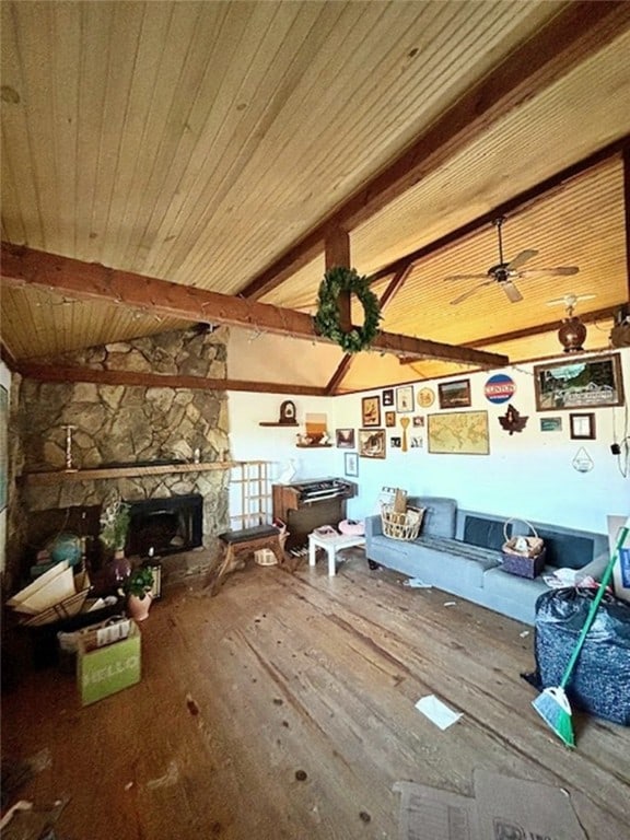 unfurnished living room featuring ceiling fan, vaulted ceiling with beams, hardwood / wood-style floors, a fireplace, and wood ceiling