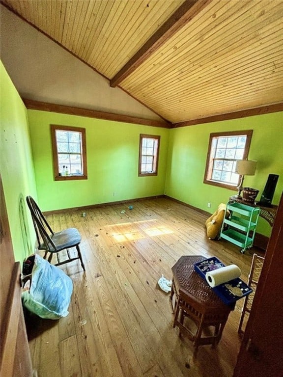 interior space featuring vaulted ceiling with beams, hardwood / wood-style floors, and wood ceiling