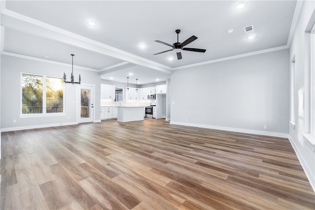 unfurnished living room featuring ornamental molding, ceiling fan with notable chandelier, and light hardwood / wood-style flooring