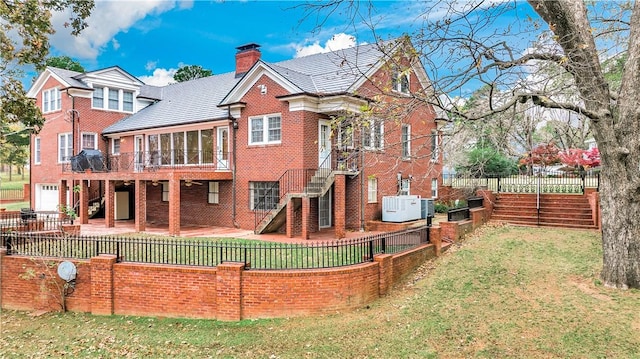 rear view of house with a yard and a patio