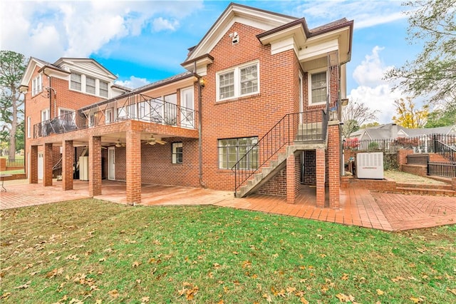 back of house featuring a yard, a patio, and a wooden deck