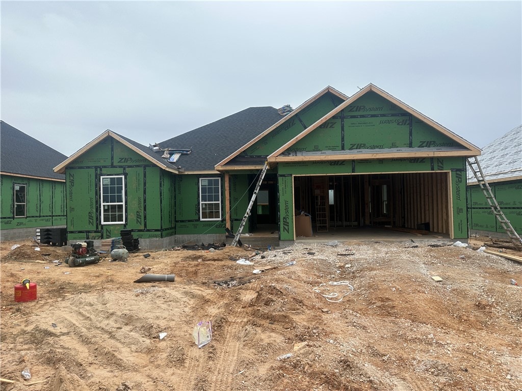 unfinished property featuring a garage and cooling unit