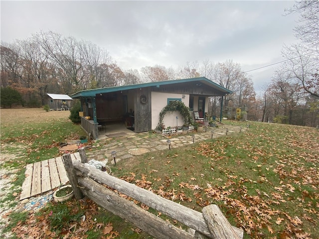 view of home's exterior featuring a yard and an outdoor structure