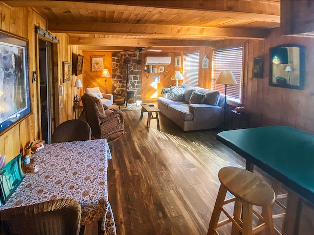 dining room with beam ceiling, an AC wall unit, wood walls, wood-type flooring, and wood ceiling