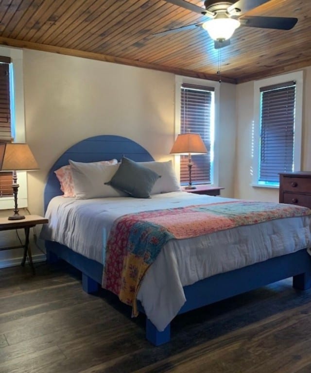 bedroom with ceiling fan, wooden ceiling, dark wood-type flooring, and ornamental molding