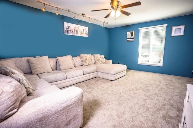 carpeted living room featuring ceiling fan and rail lighting