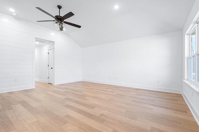 interior space with ceiling fan, lofted ceiling, a wealth of natural light, and light wood-type flooring